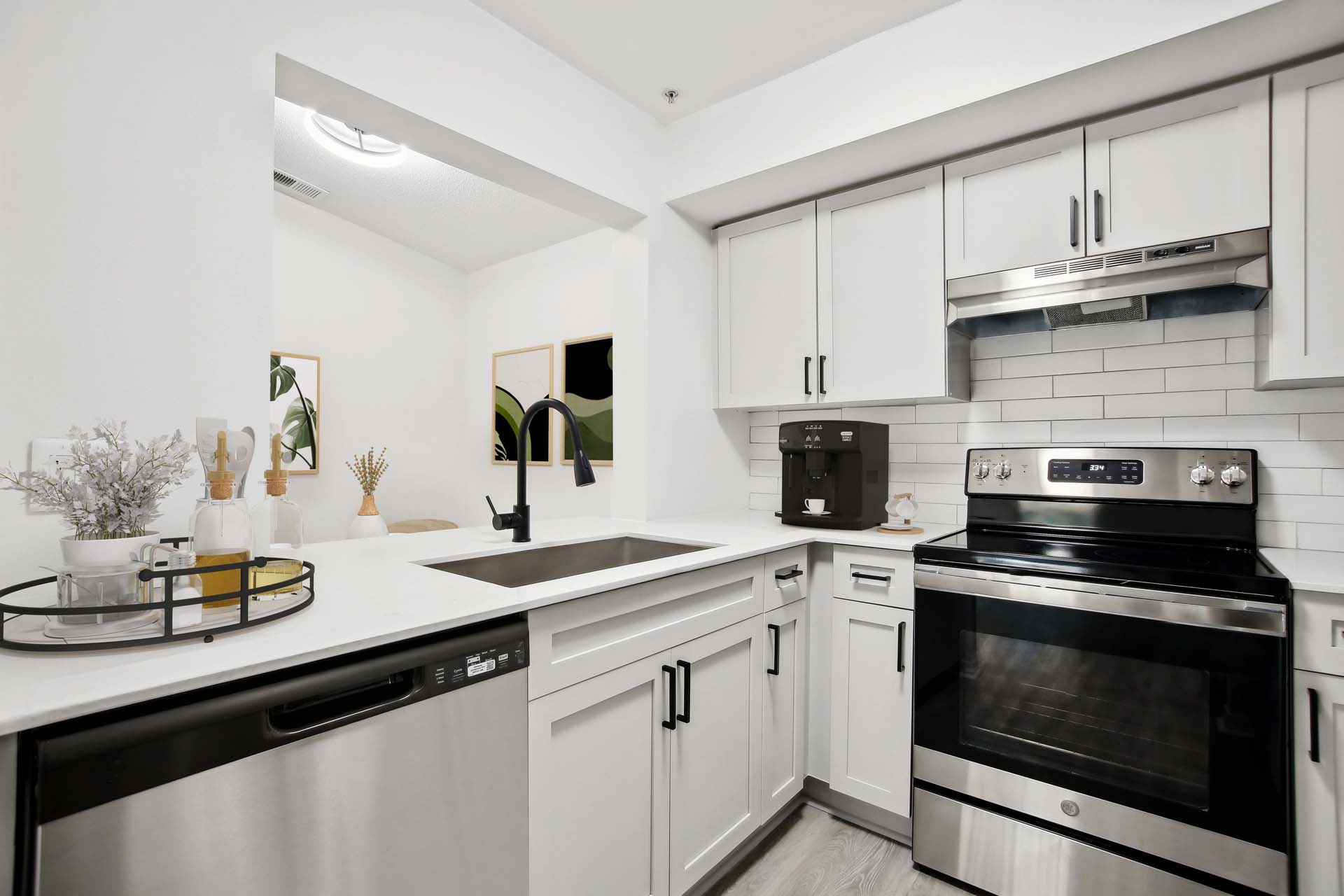 kitchen with white cabinets, white countertop and black accents
